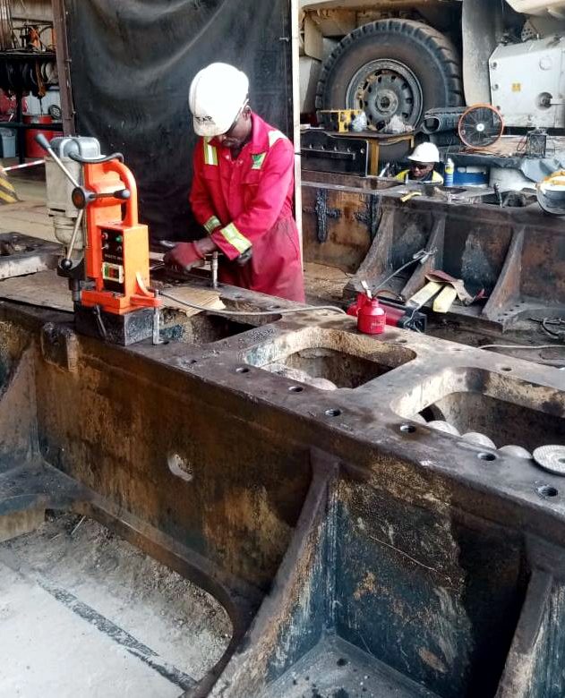 Technician in PPE performing a track frame repair